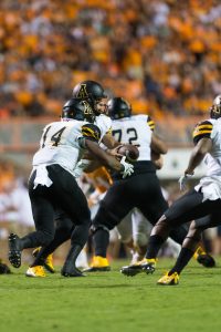 Lamb hands the ball off to running back Marcus Cox. Lamb and Cox have become one of the nation's top offensive duos. Photo by Dallas Linger