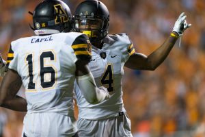 Wide Receivers Jaquil Capel and Jaylan Barbour discuss strategy against Tennessee inbetween plays last week. Photo by Dallas Linger