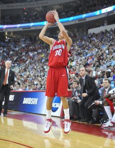 Former Davidson Basketball player Stephen Curry goes up for a shot with Fox on the sideline as an assistant coach.