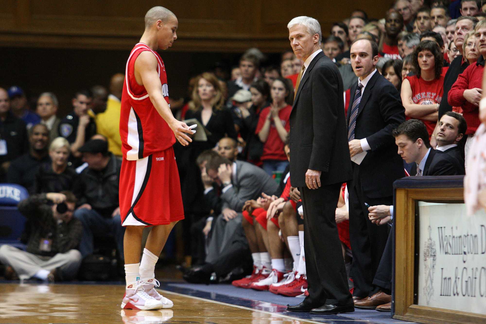 Jim Fox, standing on right, coached at Davidson for 13 years including an elite NCAA tournament run in 2008 with current NBA MVP Stephen Curry, left, and Davidson Coach Bob McKillop, middle.