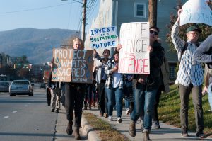 Pipeline protestors make thier way down Blowing Rock Road to the Wells Fargo Bank.