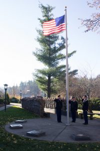 Cadets salute after the raising of the flag at the Veterans Day Ceremony on November 11 near B.B. Dougherty.