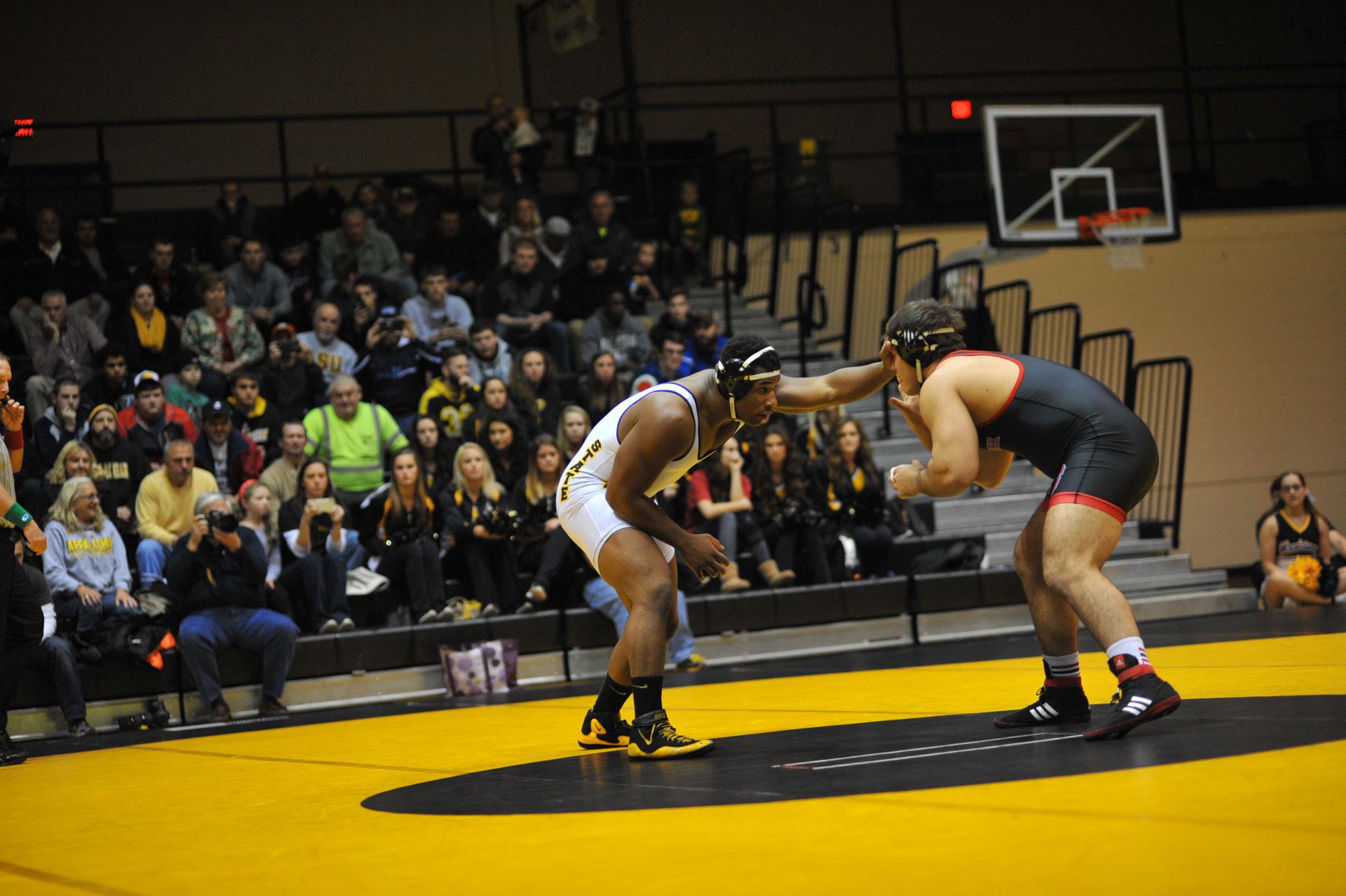 Senior, Denzel Dejournette, faces of with one of his opponents during a wresting match last season in 2015.