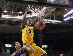 Forward Isaac Johnson goes for a dunk during the first half 