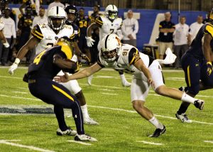 Defensive lineman Caleb Spurlin goes for a tackle. Photo credit: Braxton Critcher