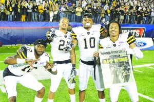 Junior, Brandon Pinckney, freshman, Clifton Duck, junior, A.J. Howard, and senior, Mondo Williams, all defensive backs, celebrate the win of the Camillia Bowl against Toledo in Montgomery, Alabama.