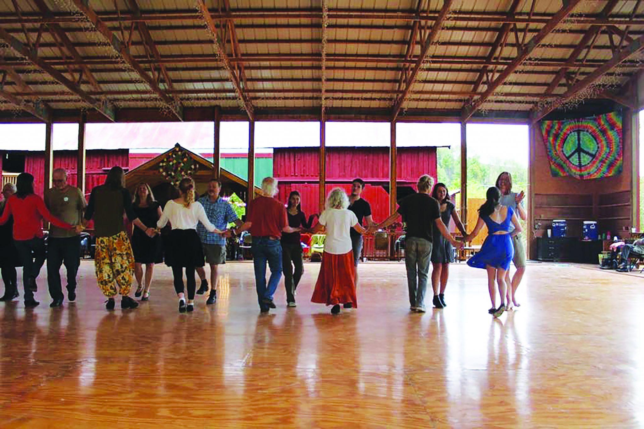 People dancing in two lines facing eachother at a 12-hour contra dance called Boonedoggle. The event was hosted by the Boone Contra Dancers on October 8.