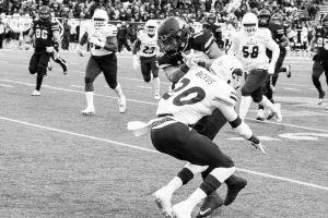 Senior running back Marcus Cox, attempts to run the ball down the field and gets tackled by the opposing team during the game against UL Monroe.