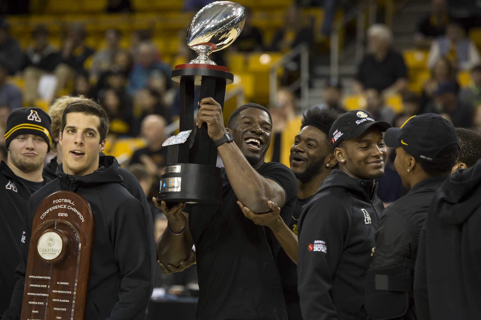 App State footballs Keenan Gilchrist hoists the Mountaineers second Camellia Bowl trophy in two years. 