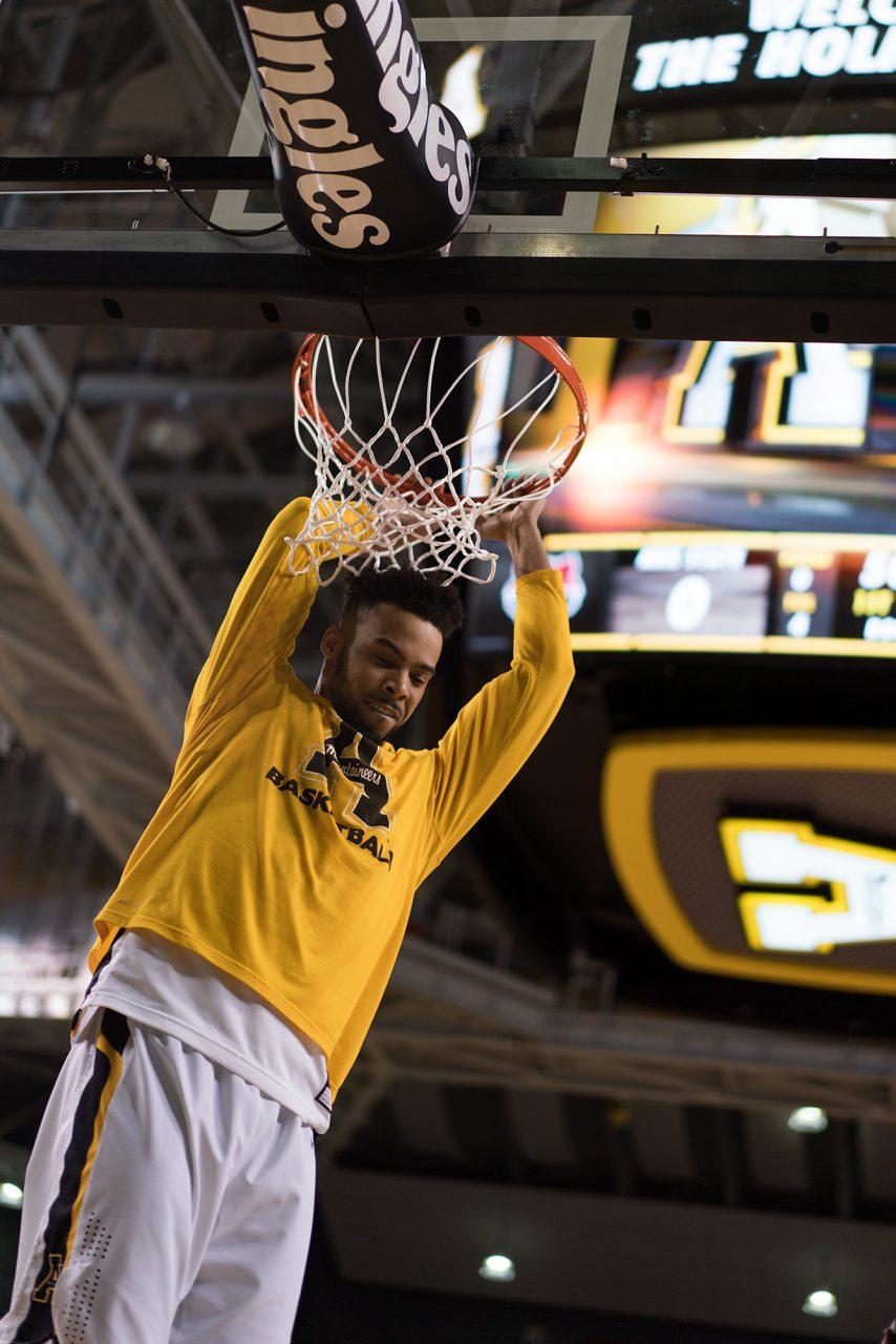 Craig Hinton hangs from the rim as the mountaineers prepared to face Arkansas State. 