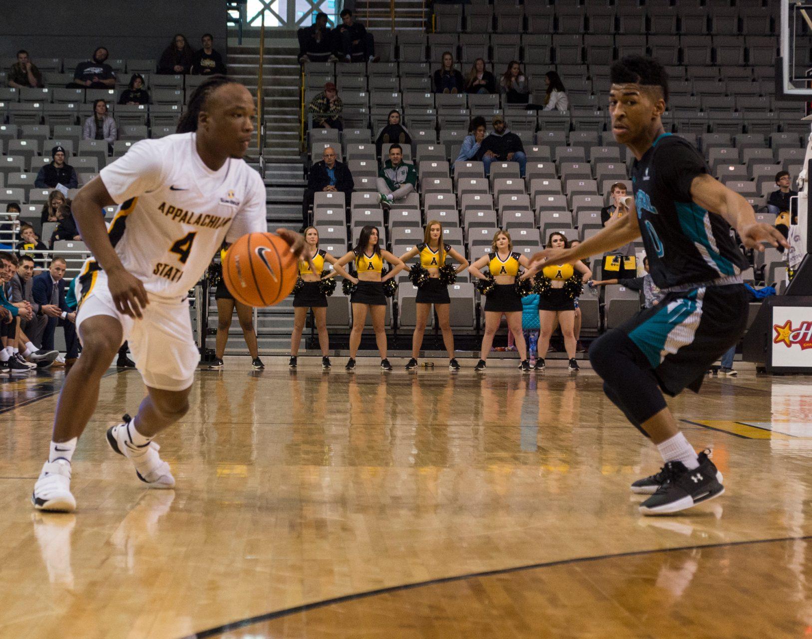 Sophomore guard OShowen Williams checks with teammates before passing the ball during the game against Coastal Carolina on Saturday, March 3rd. 