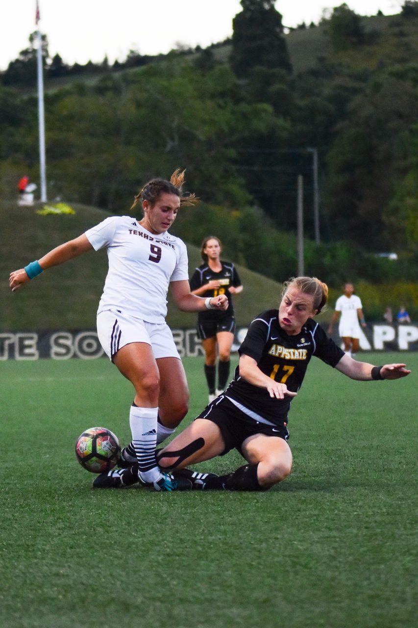 Sophomore midfield/foward Tess Cairney goes for a tackle against Texas State in 2017. 