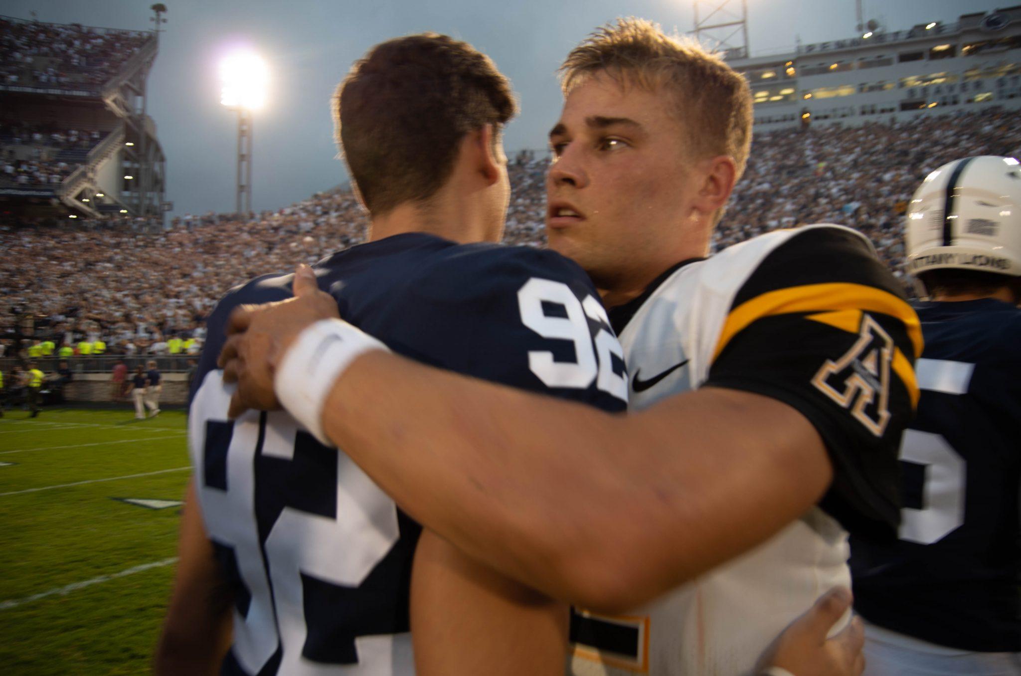 Redshirt sophomore quarterback Zac Thomas embraces a Penn State player following their loss to the Nittany Lions on Saturday.