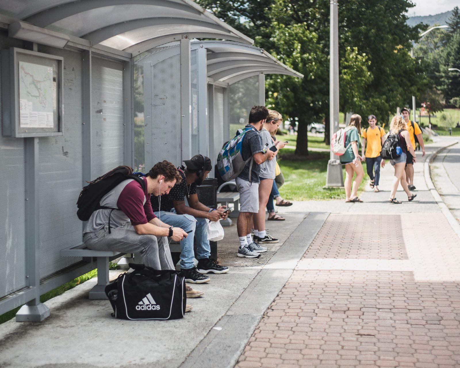 Students waiting to board an AppalCart in front of Garwood Hall.
