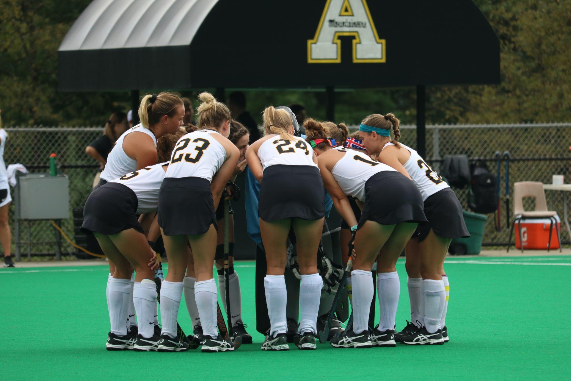 Field hockey huddles up during their home game against Louisville. 