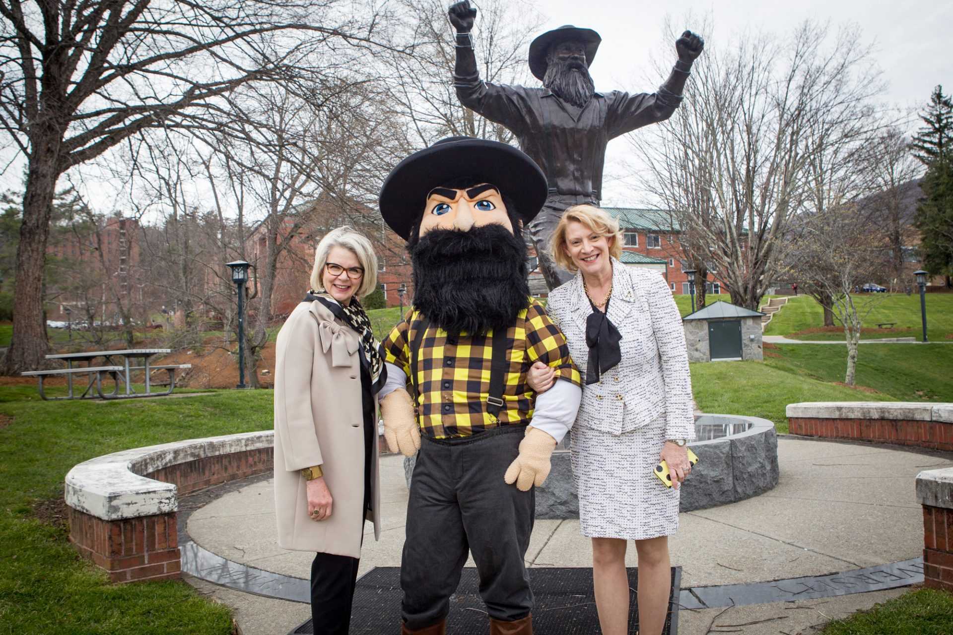 University of North Carolina System President Margaret Spellings and Chancellor Everts stand in front of the Yosef statue with Yosef.