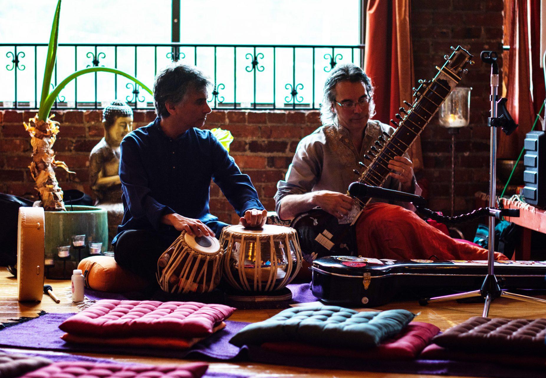 Rob Falvo (left) and Todd Bush (right) rehearse with their instruments prior to the evenings performance. They played a melody called Raga Saraswati in dedication to the goddess of art, music, and knowledge.