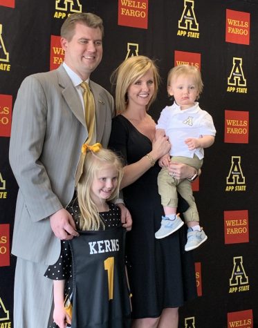 New head basketball coach Dustin Kerns pictured with his wife Brittany, daughter Emory and son Riggs. 