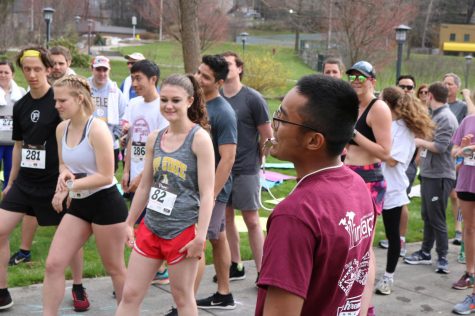 Gerard Ramos blows the starting whistle at INTAPP's Coffee Buzz 5K in 2019.  participants b 5K. The organization raises money for students to be able to study abroad.