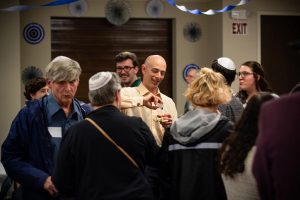 Locals celebrate following the Pride Shabbat service on Friday evening. About 40 people gathered to commemorate the LGBTQ community on Judaisms weekly day of rest.