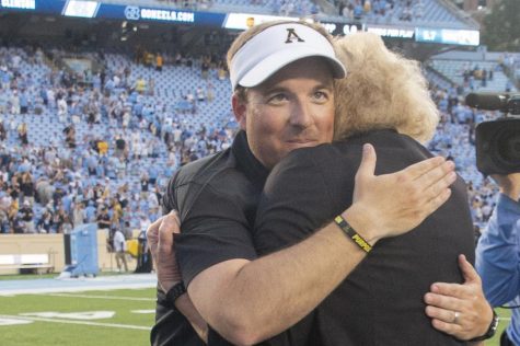 Former head coach Eliah Drinkwitz embraces App State chancellor Sheri Everts after defeating UNC. 