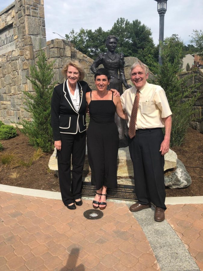 Chancellor Sheri Everts, Suzie Hallier, and William H. Brown Jr. stand together in front of the newly dedicated statue that was unveiled at the Founders Day ceremony. The statue depicts Lillie Shull Dougherty and stands near the new campus sign in Durham Park.