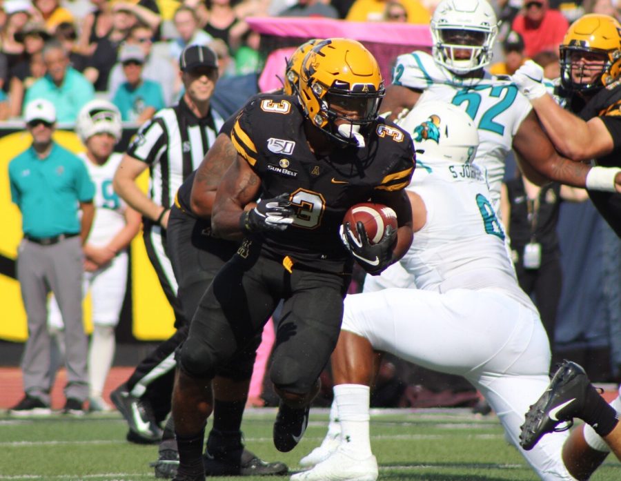 Junior running back Darrynton Evans runs with the ball during the first quarter of App State's matchup with Coastal Carolina on Sept. 28. 