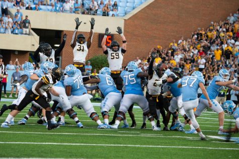 Senior linebacker Jordan Fehr and redshirt freshman outside linebacker Nick Hampton jump to block a field goal on the final play of the game to seal the 34-31 victory for the Mountaineers.
