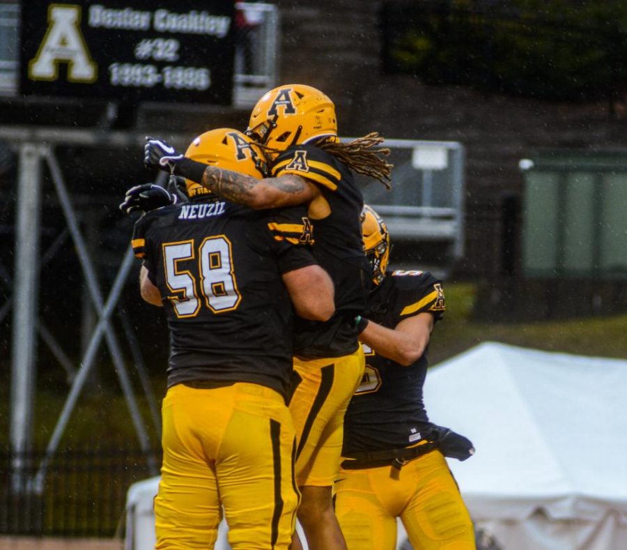 Junior WR Corey Sutton celebrates his touchdown in the first quarter with teammates. App State went on to beat Texas State 35-13 on Nov. 23. 