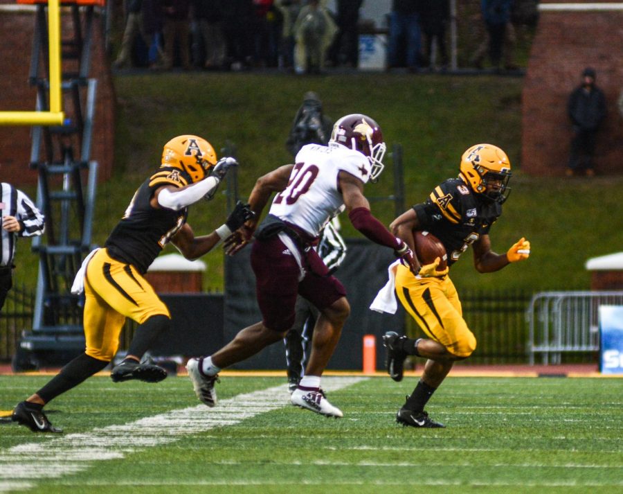 Junior running back Darrynton Evans looks for a hole during App States 35-13 win over Texas State on Nov. 24.