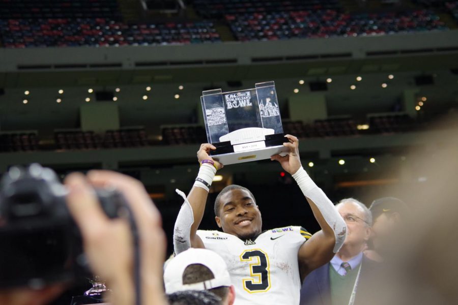 New Orleans Bowl MVP Darrynton Evans hoists his trophy. Evans rushed 19 times for 153 yards and a touchdown.