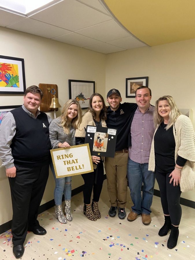 Connor Coker (second from right) celebrates with his friends after ringing the bell to announce he is cancer free after three years. Coker was diagnosed in 2016 and had to leave App State for a year for treatment.