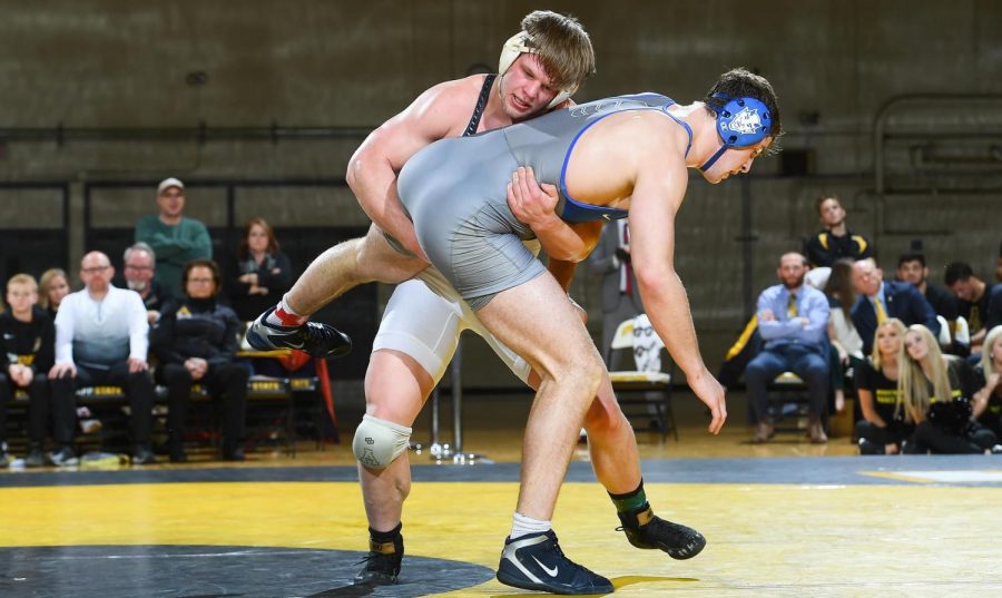 Senior heavyweight Cary Miller takes hold of an opponent from Duke University during their face off on Jan. 24. Mill-
er is a Greensboro native and has wrestled since middle school.