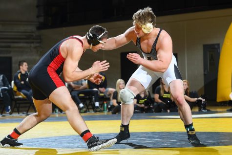 Senior heavyweight Cary Miller in action against Davidson on Jan. 12. Miller recorded a pin in the first round.