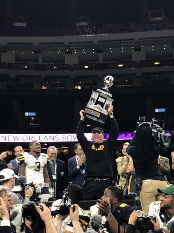 Head football coach Shawn Clark hoists the New Orleans Bowl trophy after App State's 31-17 win over UAB on Dec. 21.