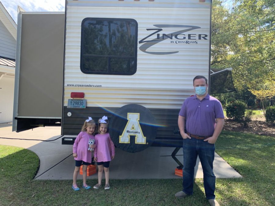 Robert Craven and his two daughters stand outside the RV donated to their family from App State alumnus David Small and his wife, Stacey.