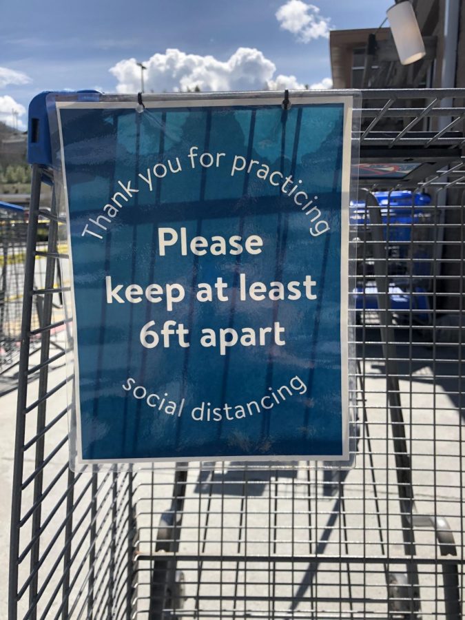 Signs line the carts leading into the Boone Walmart asking people to social distance and remain 6 feet apart. 