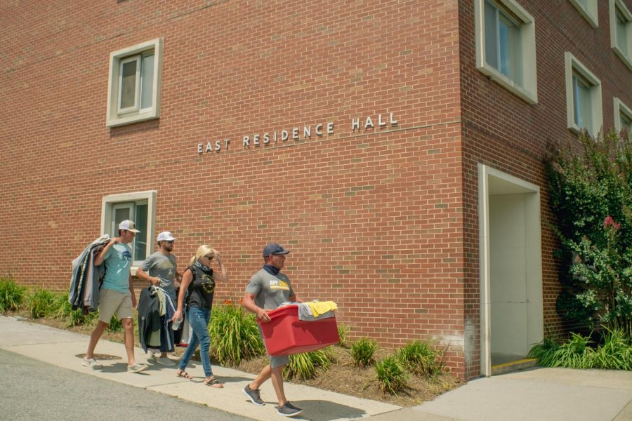 Family and friends assist students moving in to residence halls August 10. People wait outside with items ready to be moved in, following social distancing orders.