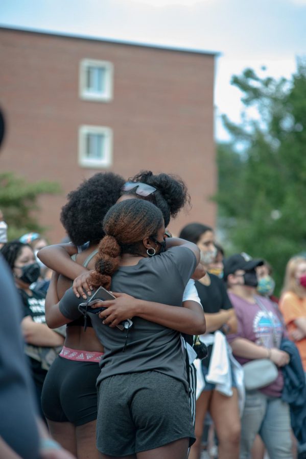 Coalition leader Kynda Bichara is embraced by two friends in front of the B.B. Dougherty.