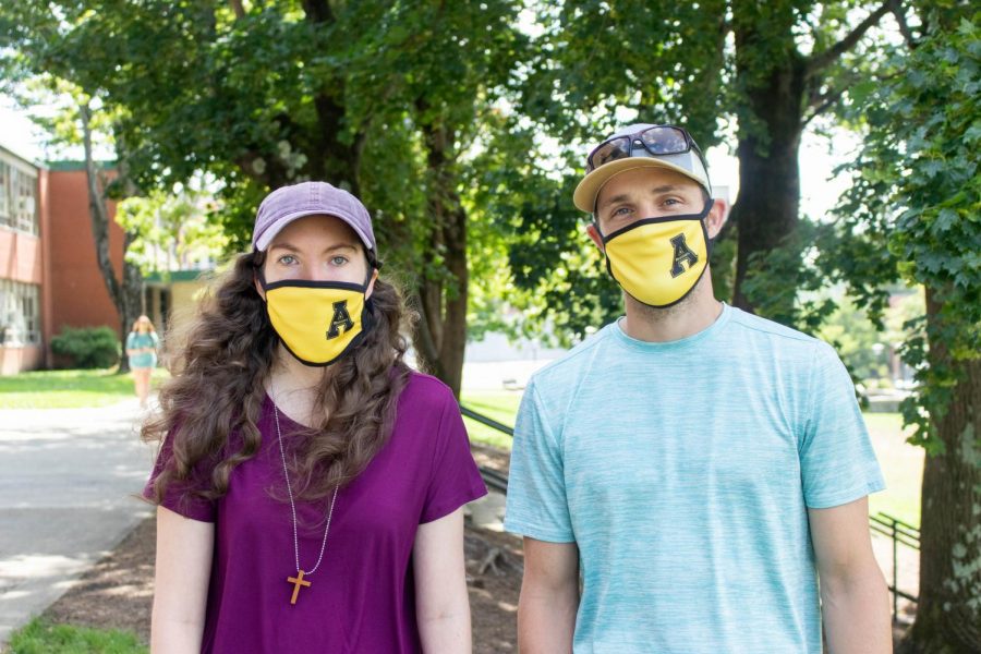 Noel Smith and John Troutman of Campus Christian Fellowship sport their yellow App State provided masks while talking to fellow students about their campus ministry.