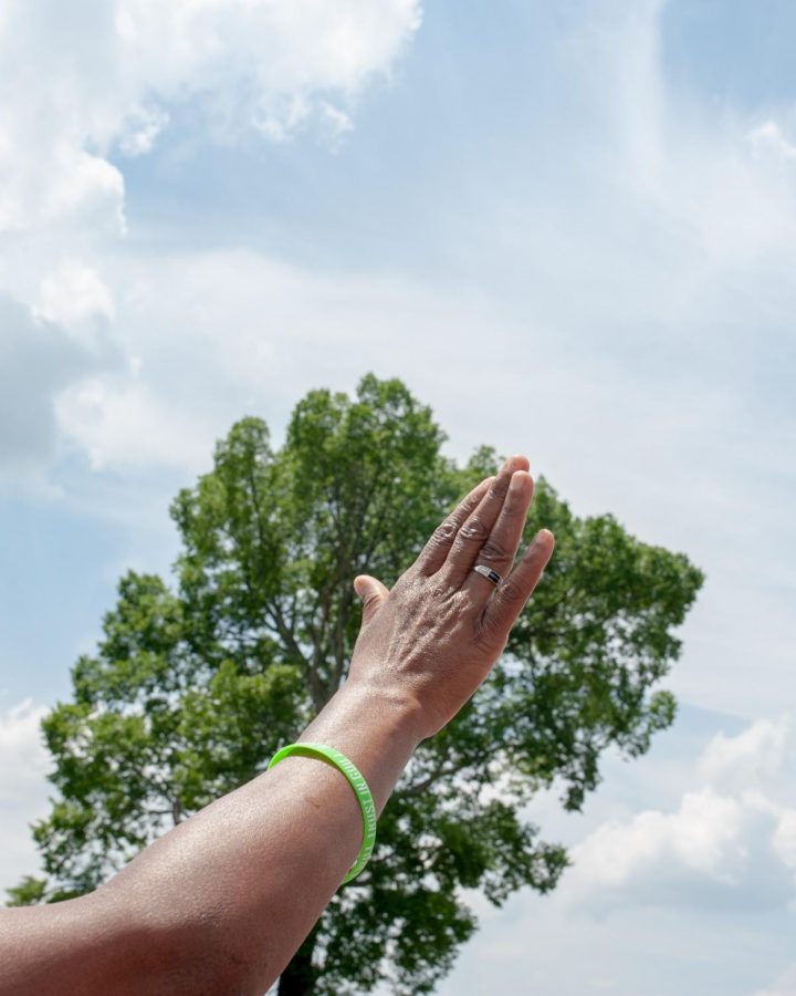 A participant holds up her hand while someone sings Andre Days Rise Up at the end of the demonstration to end police brutality in Hickory, North Carolina June 6.