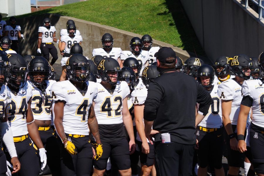 App State head coach Shawn Clark briefly speaks to his team before they take the field against Marshall. 