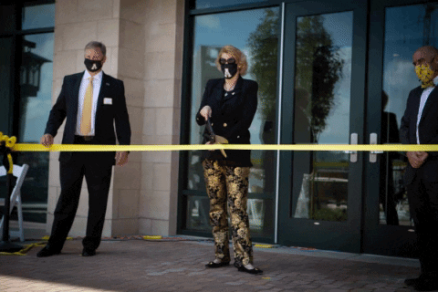 Chancellor Sheri Everts cuts the ribbon on Raven Rocks Residence Hall Thursday. Raven Rocks is one of two new dorms that were built on West Campus this year. 