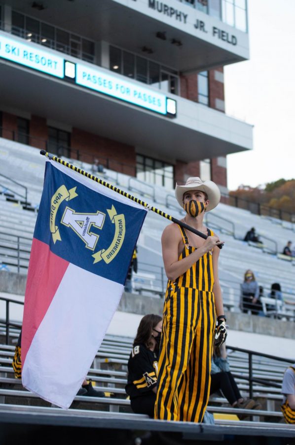 Students decked out in black and gold begin to fill in the student section before the game Oct. 22. A crowd of 2,100 people were welcomed back to The Rock to watch the Mountaineers face off against Arkansas State. Masks and social distancing were enforced.