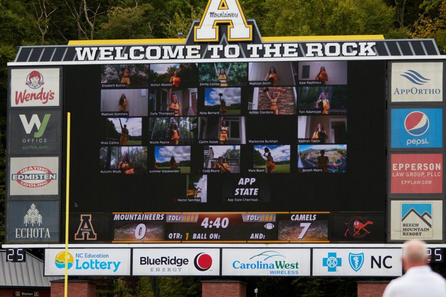 Members of App States cheerleading team cheer on the Mountaineers virtually from the video board inside Kidd Brewer Stadium in the win over Campbell Sept. 26.