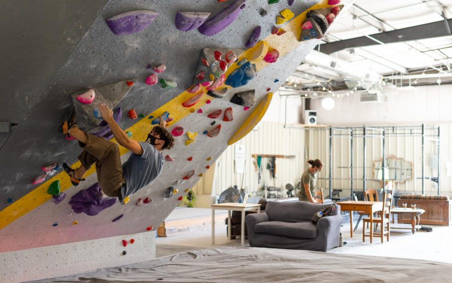 Daelan, an avid climber in Boone, NC, is able to keep strong during the bouldering season by climbing with a mask on at Center 45 on October 1.