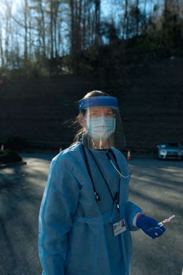 Melinda Bogardus, a family nurse practitioner, works to administer the Moderna vaccine to patients waiting in the parking lot. Bogardus has yet to receive the vaccine. Im on the list, she said. Bogardus said she will be receiving the vaccine at the end of the day as a safeguard for side effects that come with the vaccination process.