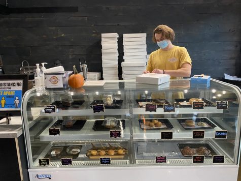 Nick Cellini prepares an order behind the counter at Hole Lotta Doughnuts on King Street. The West Jefferson-based shop opened this fall in Boone after popular demand from customers.
