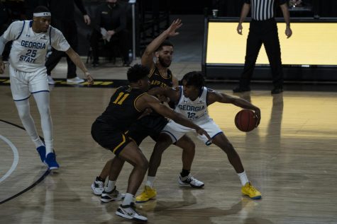 App State players Donovan Gregory (#11, left) and Deshon Parker (right) swarm Georgia State guard Kane Williams during the Mountaineers 74-61 win on Saturday at the Holmes Center.