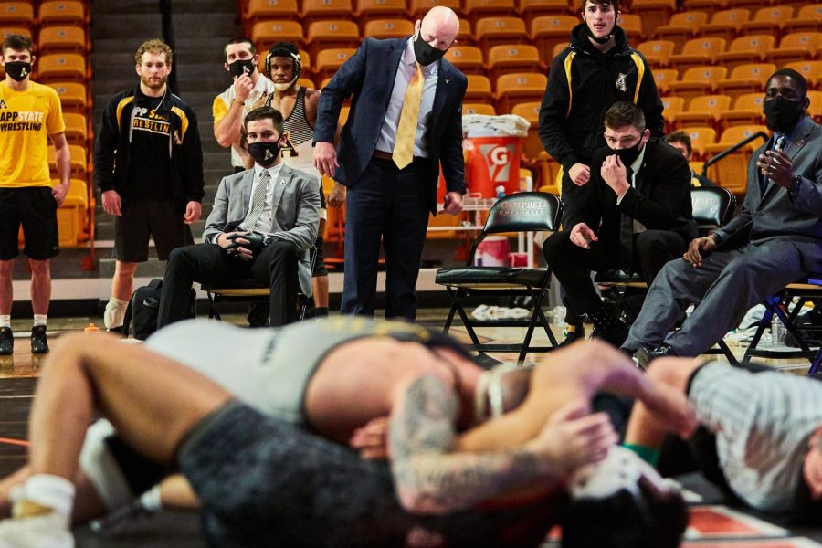 App State wrestling coaches focus on a match between senior Codi Russell and an opponent from Gardner-Webb on Jan. 23 in Buies Creek. (From right: assistant coach Randall Diabe, head assistant coach Ian Miller, head coach JohnMark Bentley.)